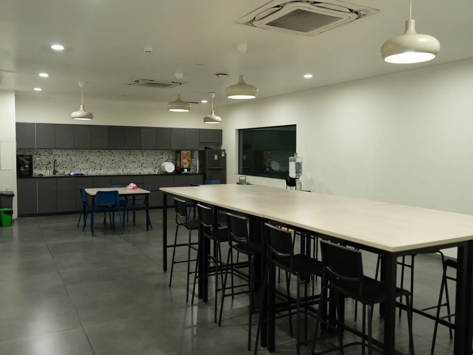Office cafeteria with long high table and pantry — LICO